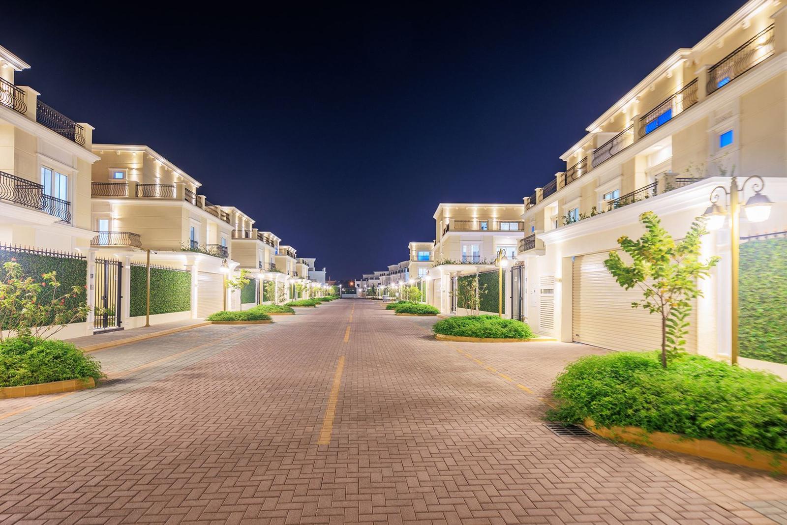 Floresta Gardens villas on The Pearl at dusk, every home lit by its own scene